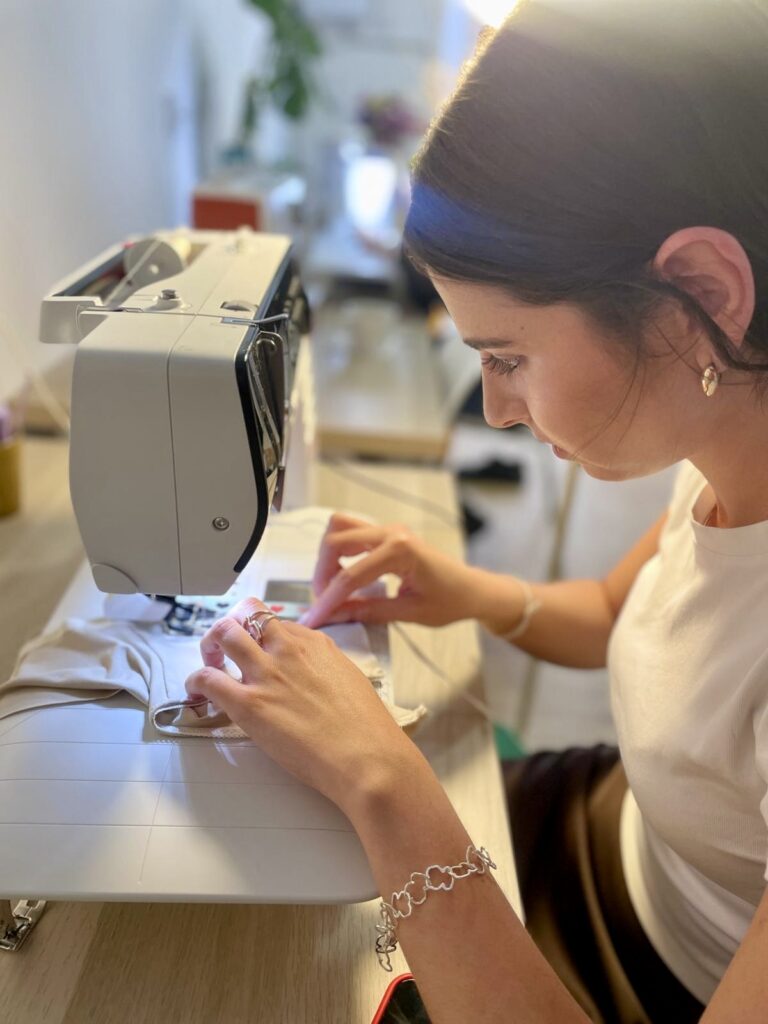 Alumna aprendiendo a utilizar la máquina de coser en Atelier Carmesí Barcelona